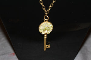 Peridot Bronze Key on chain with heart embellishments.